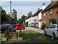 Stock village sign and view past the Hoop Public House (listed building)