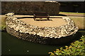 View of a seating area surrounded by a ruin of the London Wall