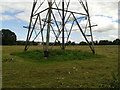 Electric pylon base in a field