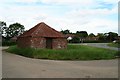 Saltfleet: brick shed on a corner by Grayfleet Bank