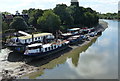 Boats moored along the south bank of the River Thames