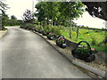 Line of flower baskets along a driveway, Oxtown