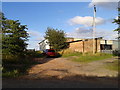 Farm buildings and a car