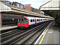 Piccadilly line train at Barons Court station