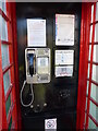 A pay phone in a telephone box