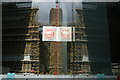 View of the Tate Modern chimney and scaffolding reflected in the Blue Fin building