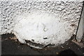 Benchmark on boulder embedded in wall of The Cross Keys