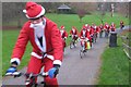 TQ3487 : Christmas Cycling Santas! by Dave Pickersgill