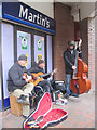 Buskers playing to pre-Xmas shoppers in Dolphin Square, Tring