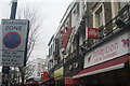 View of a large Converse on the Scorpion Shoes frontage and pine chair on the Old and New frontage from Chalk Farm Road