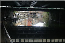 TQ2883 : View of reflections of the towpath in the canal from beneath the railway bridge by Robert Lamb