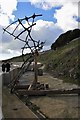 Sculpture by sea wall walkway