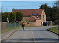 Cyclist passing Grange Farm