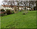 Wooden bench on a grass bank,  Pucklechurch