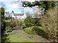 House and garden seen from footpath on golf course