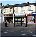 Gloucester Road bus stop and shelter opposite an entrance to Cheltenham Spa Railway Station