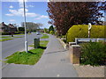 Looking west on Heathcote Drive with footpath junction on right