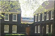 TQ3383 : View of a London Overground train pulling into Hoxton station from the Geffrye Museum grounds by Robert Lamb