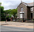 Black signpost near a stone house, Heol Eglwys, Ystradgynlais