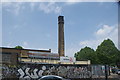 View of graffiti on the wall of Actavo and the Actavo chimney from Stour Road