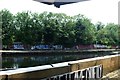 View of a wall of street art on the River Lea towpath from the Plough Cafe