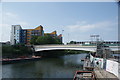 View of the Twelvetrees Crescent bridge from the raised pathway at the confluence of the River Lea and Limehouse Cut