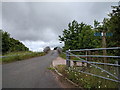 Public footpath signs and farm track crossing the A30