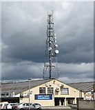 J0406 : Telecommunications mast appearing to tower above Cash and Carry Kitchens by Eric Jones