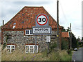 TL9978 : Hopton Village Name sign on the B1111 Bury Road by Geographer
