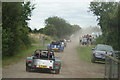 TQ5583 : View of a convoy of Caterhams leaving Havering Mind's Wings and Wheels event at Damyns Hall Aerodrome by Robert Lamb