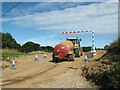 Tractor and bowser driving onto the construction site