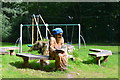 Wooden wizard in the playground at Capelulo