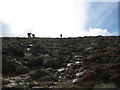 J3326 : Walkers ascending towards the summit of Slievelamangan by Eric Jones