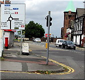 SJ8989 : Directions sign on the approach to a roundabout near Stockport railway station by Jaggery