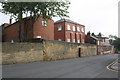 New housing behind stone wall, Kendal Lane