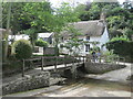 Helford Ford, footbridge and thatched cottage