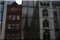 View of the Guild Church of St. Margaret Pattens reflected in the windows of Godiva on Fenchurch Street