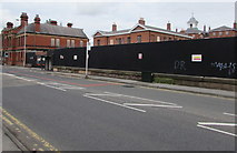 SJ8989 : Fenced-off former hospital site, Shaw  Heath, Stockport by Jaggery