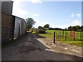 Road passing farm buildings at Lower Upton