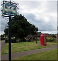 Village name sign and red phonebox, English Bicknor