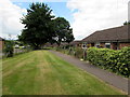 Path between bungalows and the village hall, English Bicknor 