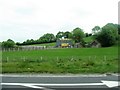 Old farm buildings on the north side of the A3