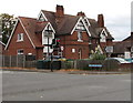 Three dark green telecoms cabinets on a Gloucester corner