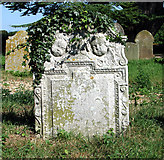 TM3794 : Ivy-clad headstone in All Saints' churchyard by Evelyn Simak