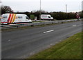 SS8679 : Two white vans on the north side of the A48 near Laleston by Jaggery