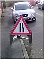 UK temporary road narrows to the right ahead sign