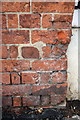 Weathered benchmark on Congregational Church wall pier