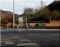 Bus stop and green shelter on an Aberbeeg corner