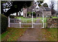 White Edwardian entrance gates to St Andrew