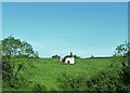 Ruined cottage in the middle of a large field above the A29